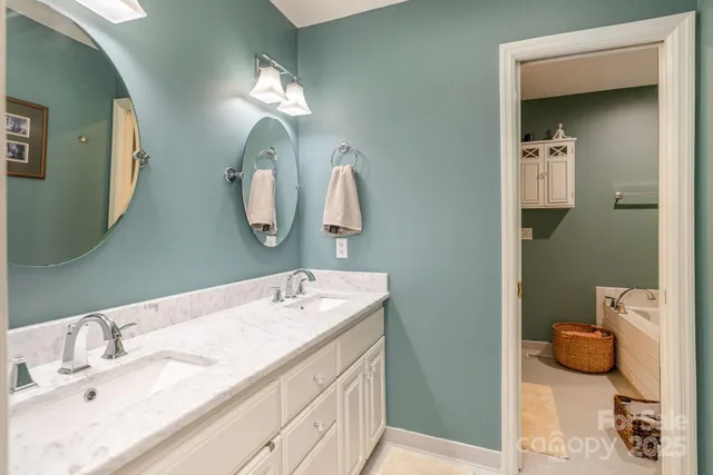 a bathroom with a double vanity sink and a mirror