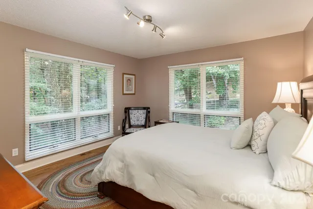 a bedroom with a bed and a large window