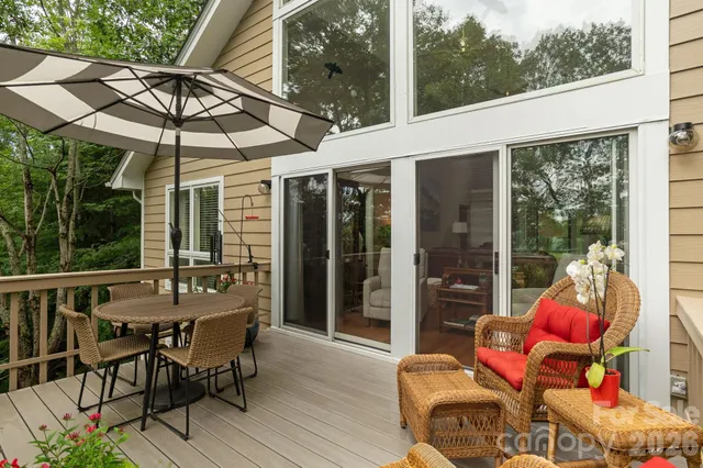 a view of a patio with table and chairs potted plants with wooden floor