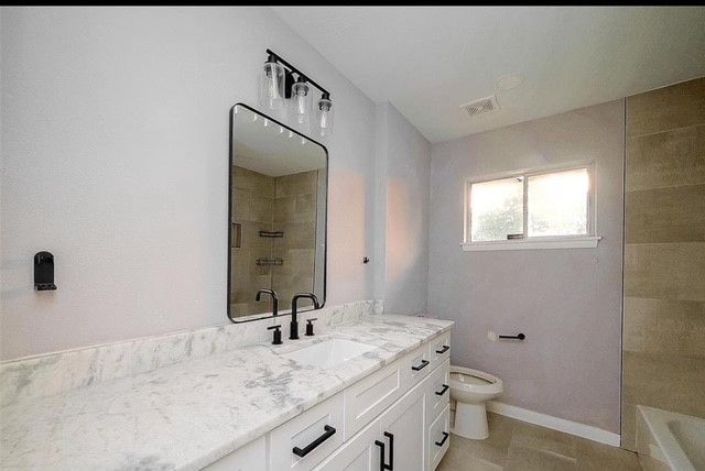 4800 Country Club View Baytown, TX 77521 - Photo 19 of 35 a bathroom with a granite countertop sink toilet and mirror