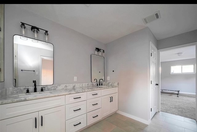 4800 Country Club View Baytown, TX 77521 - Photo 31 of 35 a bathroom with double sink and a mirror