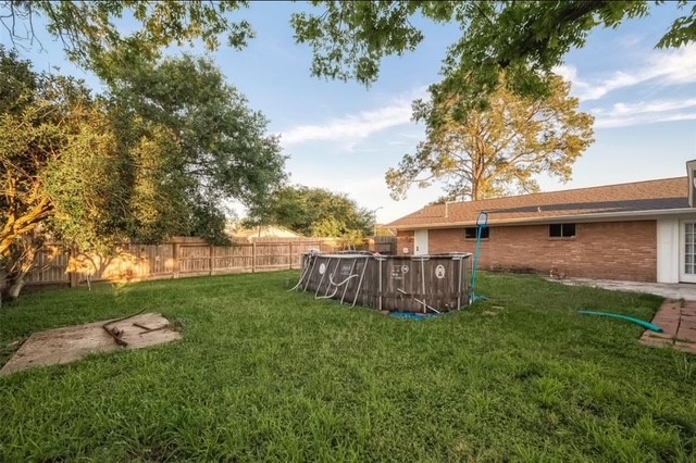 4800 Country Club View Baytown, TX 77521 - Photo 34 of 35 a view of a backyard with wooden fence and large trees