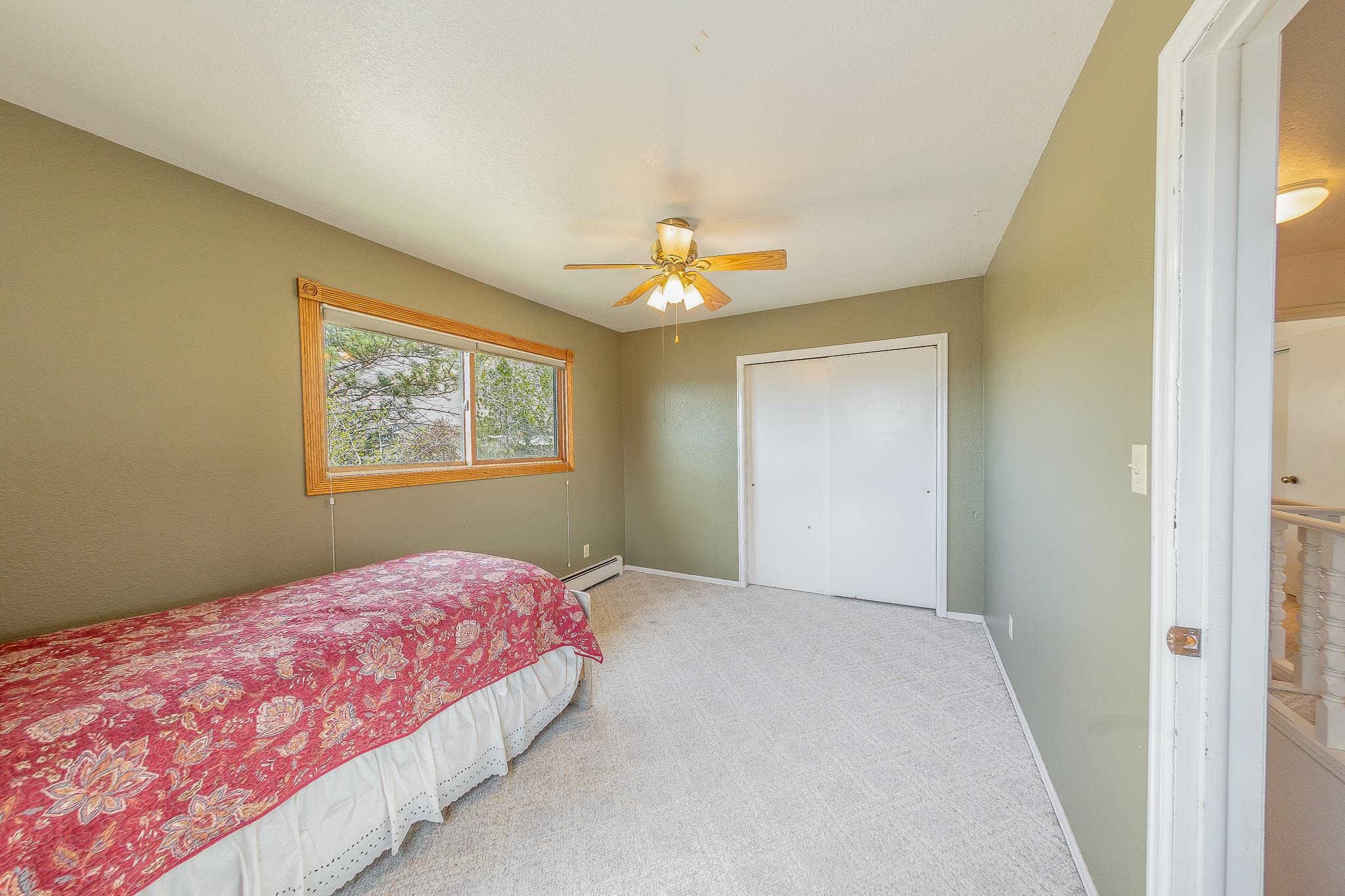 733-35 35 6/10 Road Palisade, CO 81526 - Photo 20 of 42 a bedroom with a large bed and a chandelier