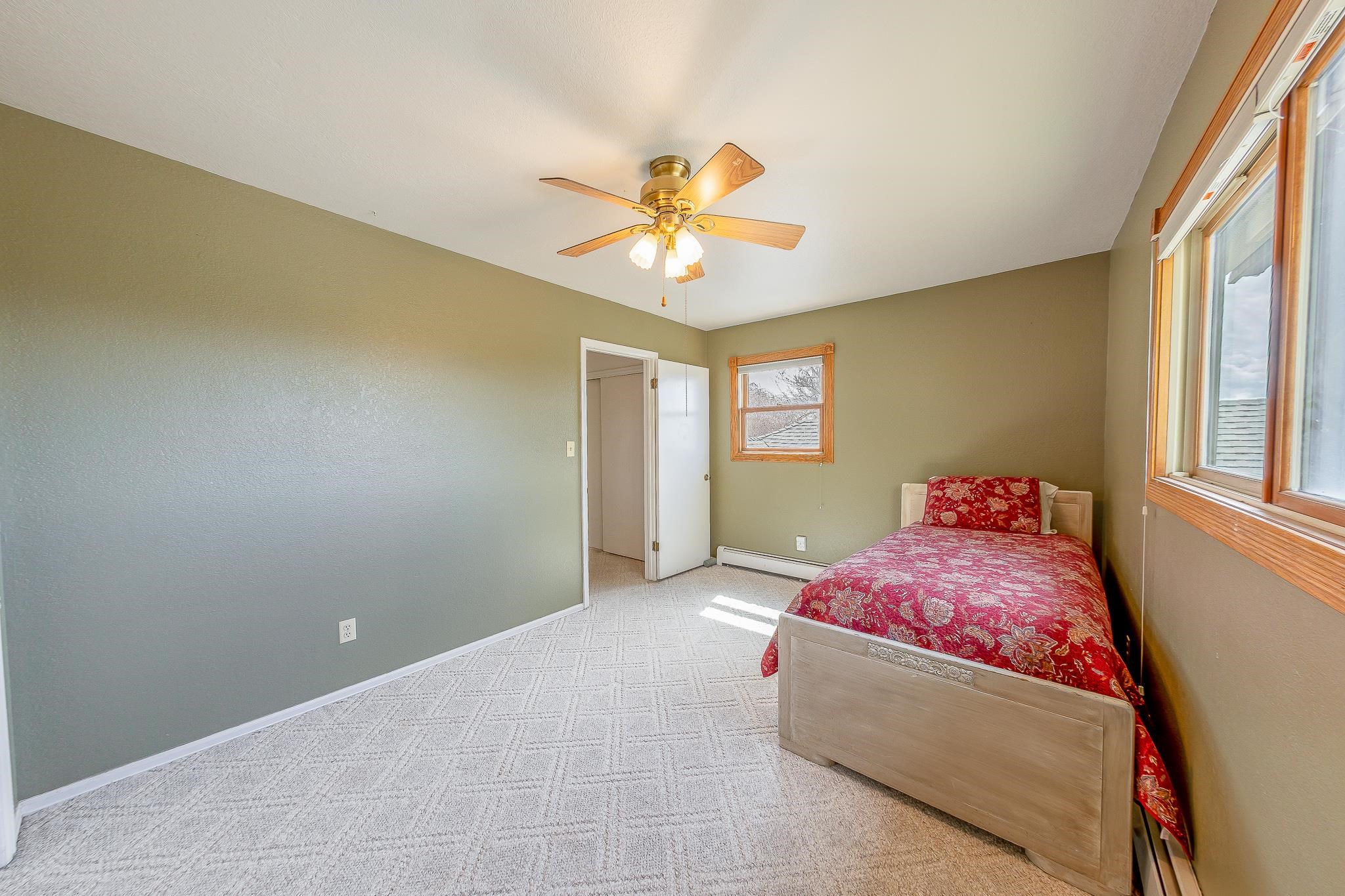 733-35 35 6/10 Road Palisade, CO 81526 - Photo 21 of 42 a bedroom with a bed and a chandelier fan