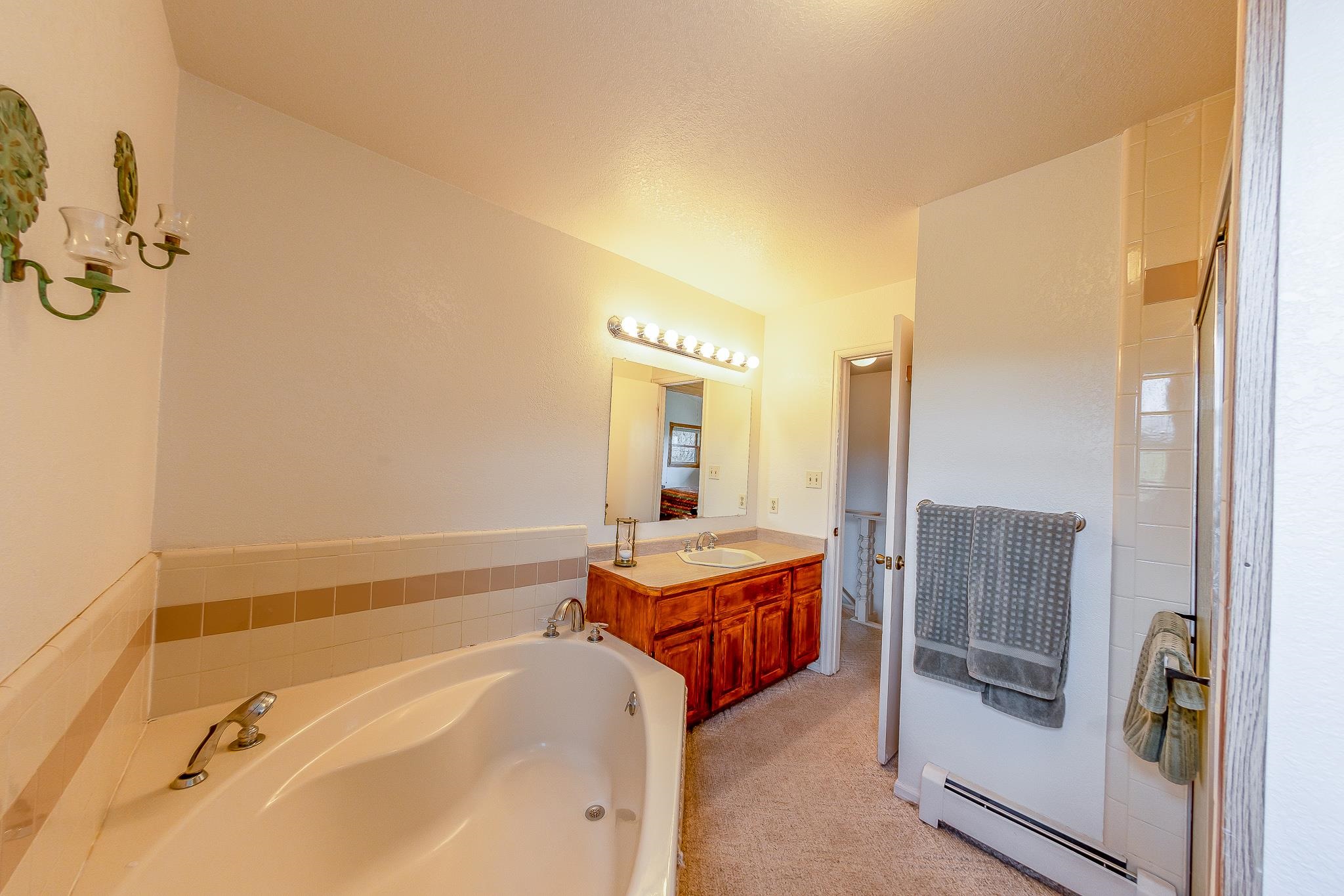 733-35 35 6/10 Road Palisade, CO 81526 - Photo 24 of 42 a spacious bathroom with a tub sink and mirror
