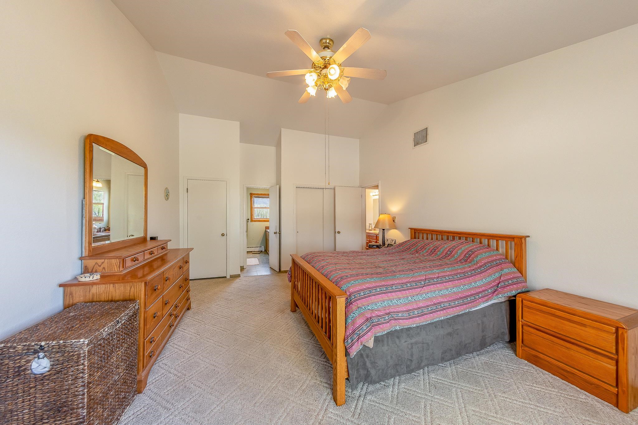 733-35 35 6/10 Road Palisade, CO 81526 - Photo 27 of 42 a spacious bedroom with a bed and a chandelier