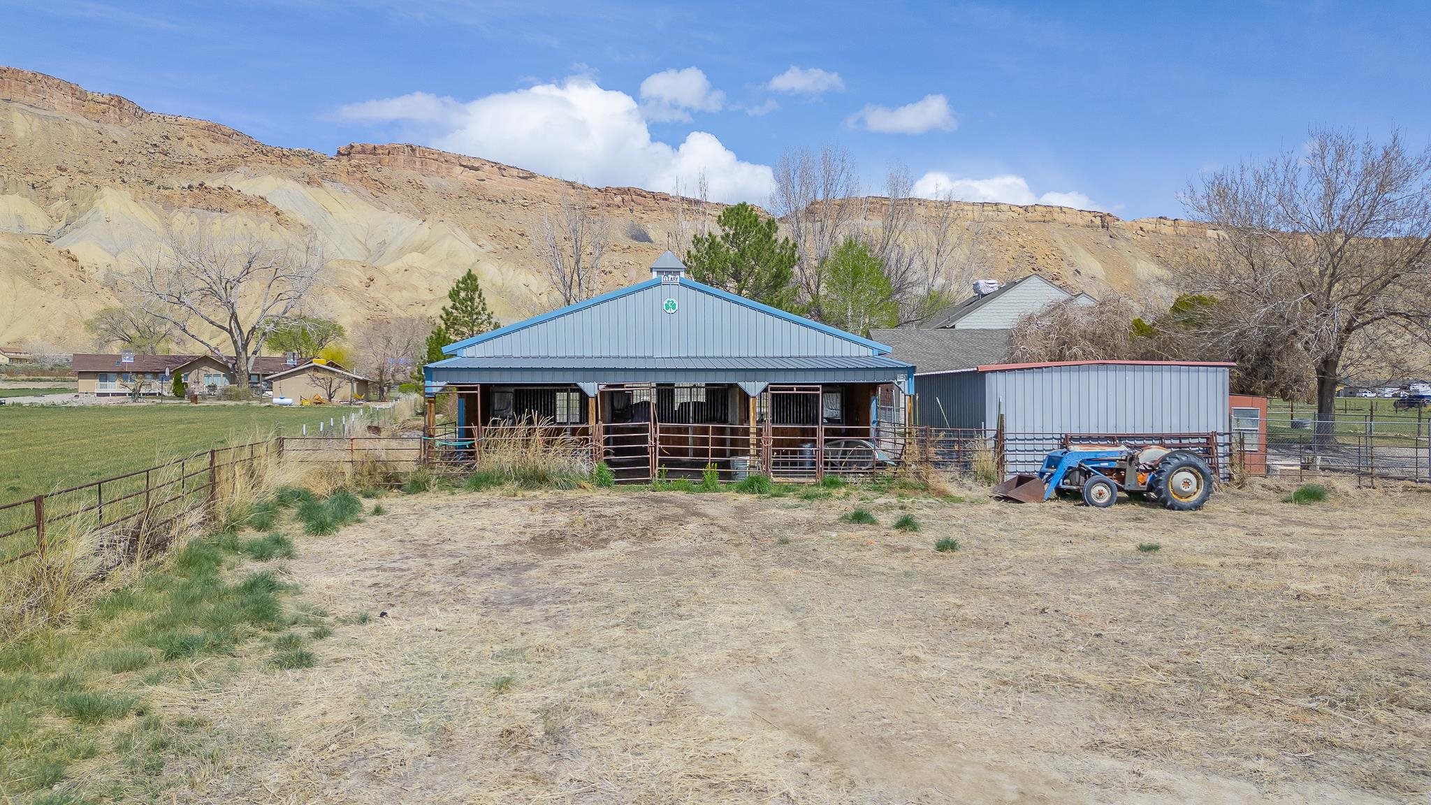 733-35 35 6/10 Road Palisade, CO 81526 - Photo 39 of 42 a front view of a house with a yard and mountain view in back