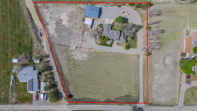 a view of a green field with mountains in the background