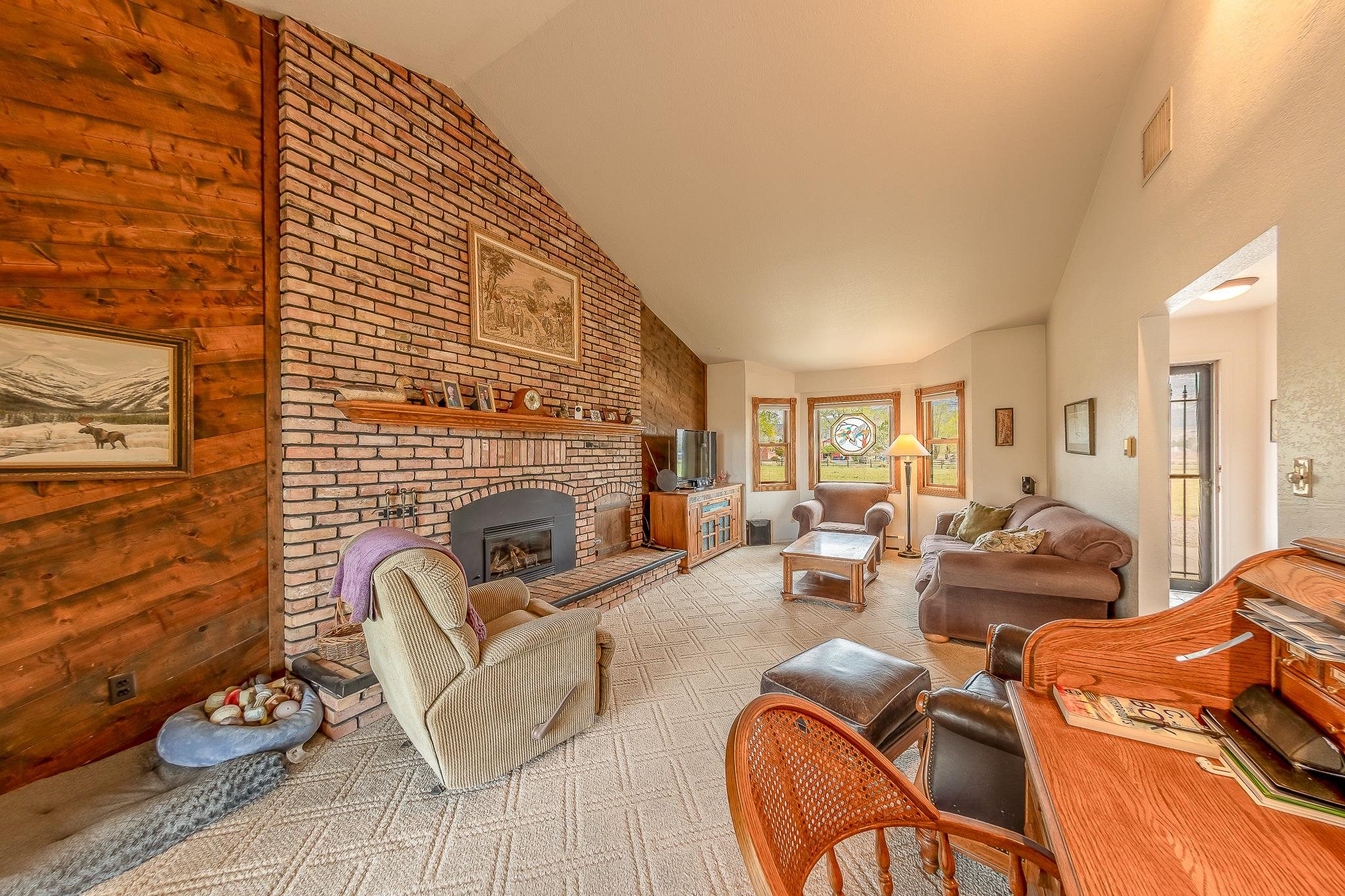 733-35 35 6/10 Road Palisade, CO 81526 - Photo 5 of 42 a living room with furniture a fireplace and a flat screen tv