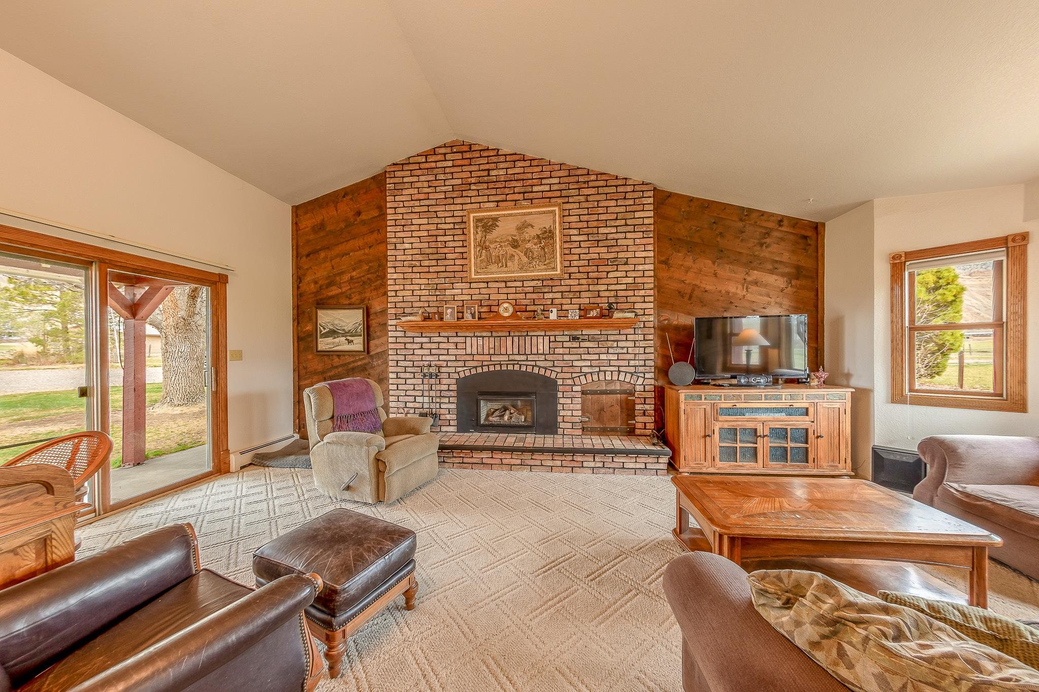 733-35 35 6/10 Road Palisade, CO 81526 - Photo 6 of 42 a living room with furniture and a fireplace
