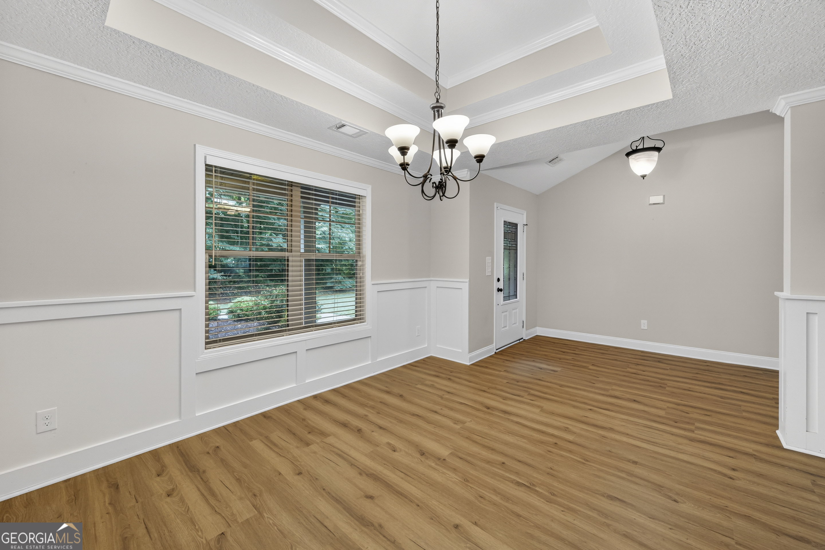 717 Oconee Lane Commerce, GA 30529 - Photo 11 of 57 a view of an empty room with a window and wooden floor