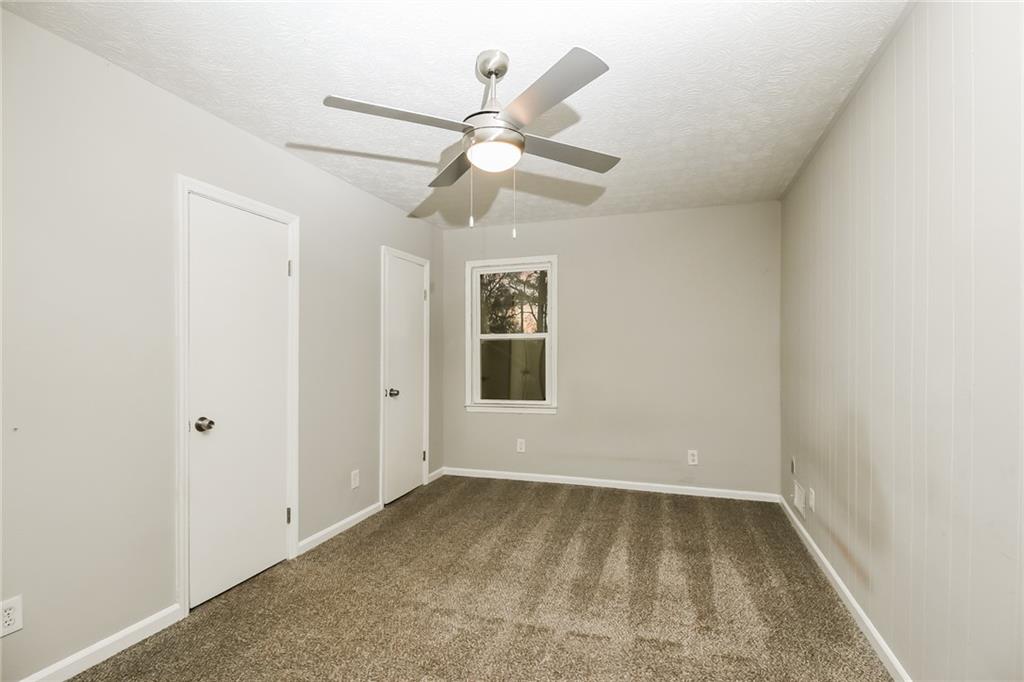 3864 McGill Lane Decatur, GA 30034 - Photo 21 of 25 an empty room with a ceiling fan and a window