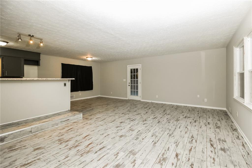 3864 McGill Lane Decatur, GA 30034 - Photo 3 of 25 a view of an empty room with window and wooden floor