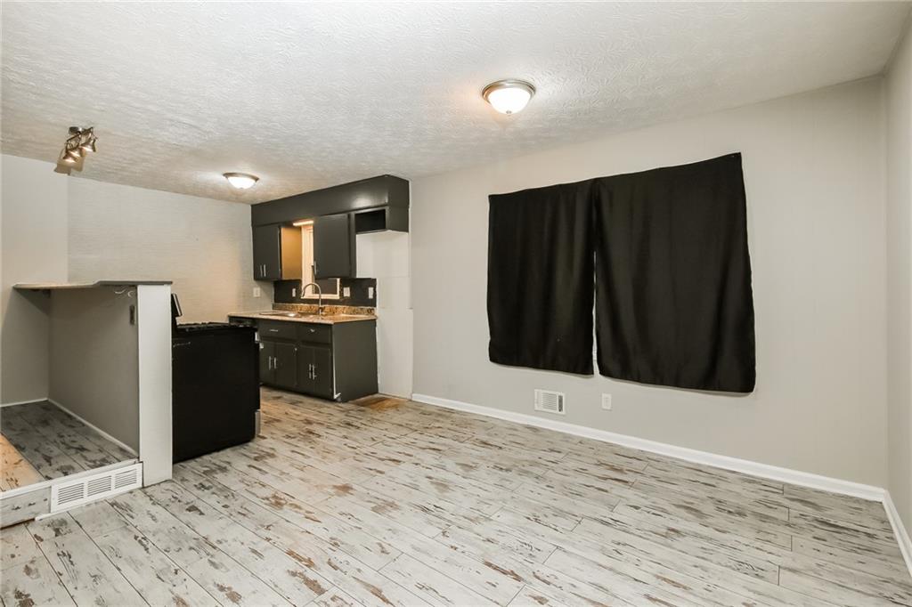 3864 McGill Lane Decatur, GA 30034 - Photo 6 of 25 a kitchen with granite countertop a refrigerator and a stove top oven