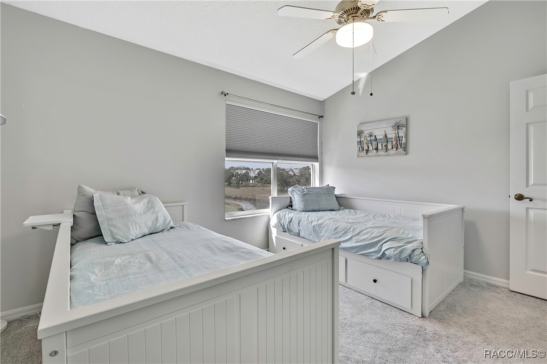2855 North Rivers Edge Boulevard, Unit 213 Crystal River, FL 34429 - Photo 31 of 62 a bedroom with a bed and a chandelier