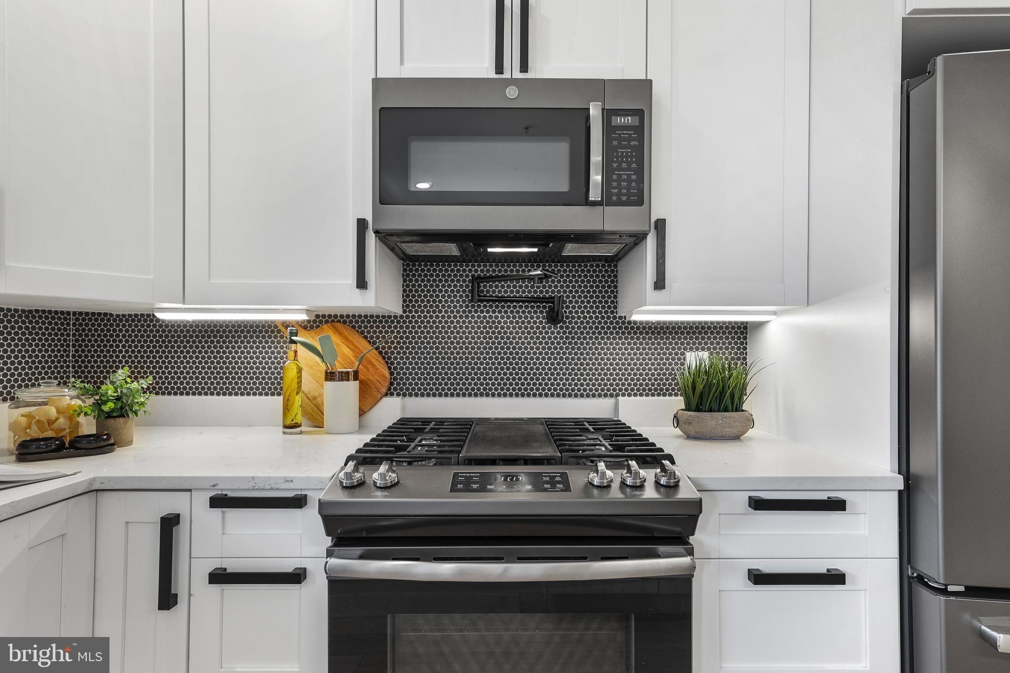 113 U Street Northeast, Unit 1 Washington, DC 20002 - Photo 20 of 63 a kitchen with a stove and a microwave