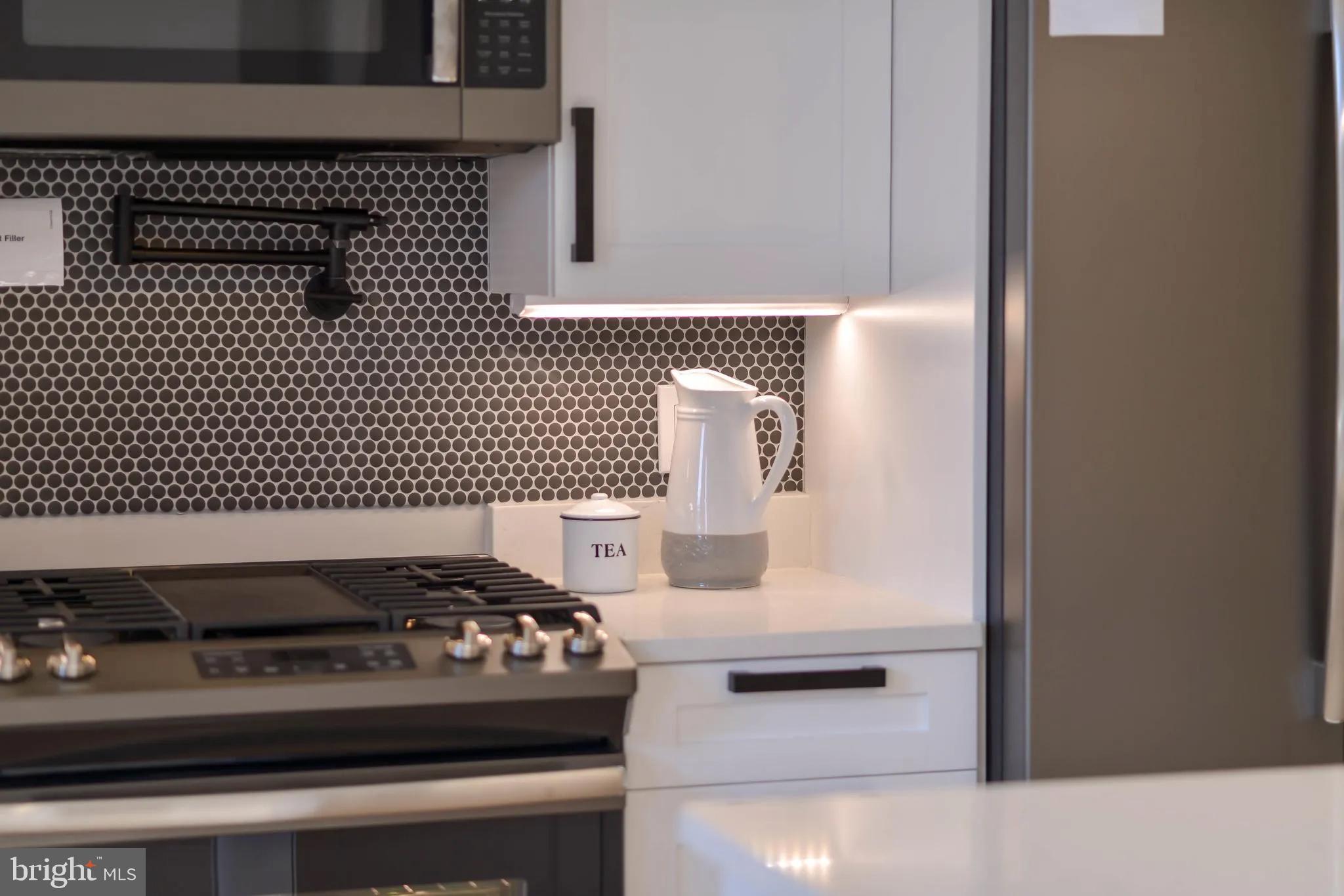 113 U Street Northeast, Unit 1 Washington, DC 20002 - Photo 21 of 63 a kitchen with a stove and a cabinet