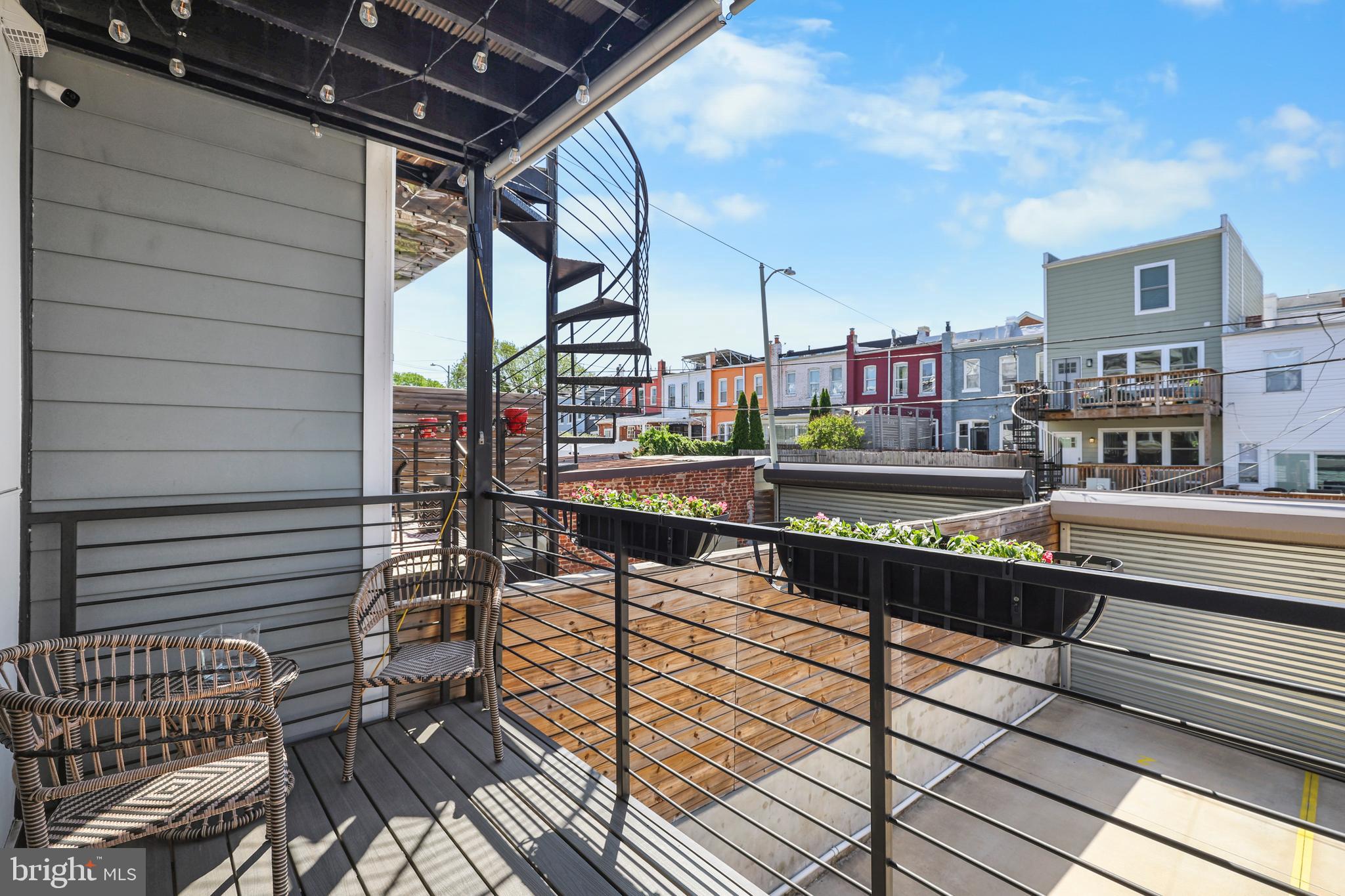 113 U Street Northeast, Unit 1 Washington, DC 20002 - Photo 26 of 63 a city view from a balcony with chairs