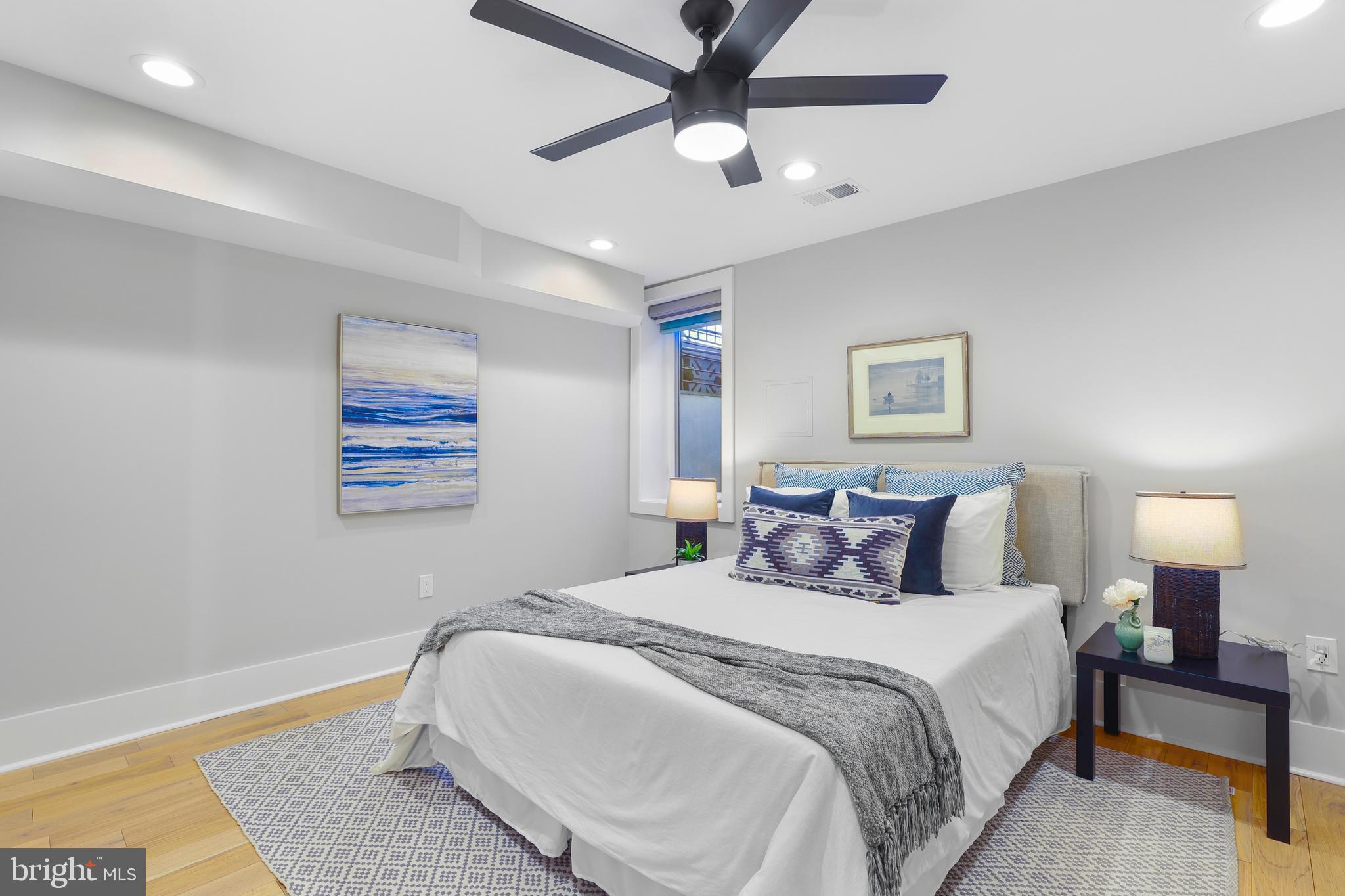 113 U Street Northeast, Unit 1 Washington, DC 20002 - Photo 29 of 63 a bedroom with a bed and a painting on the wall