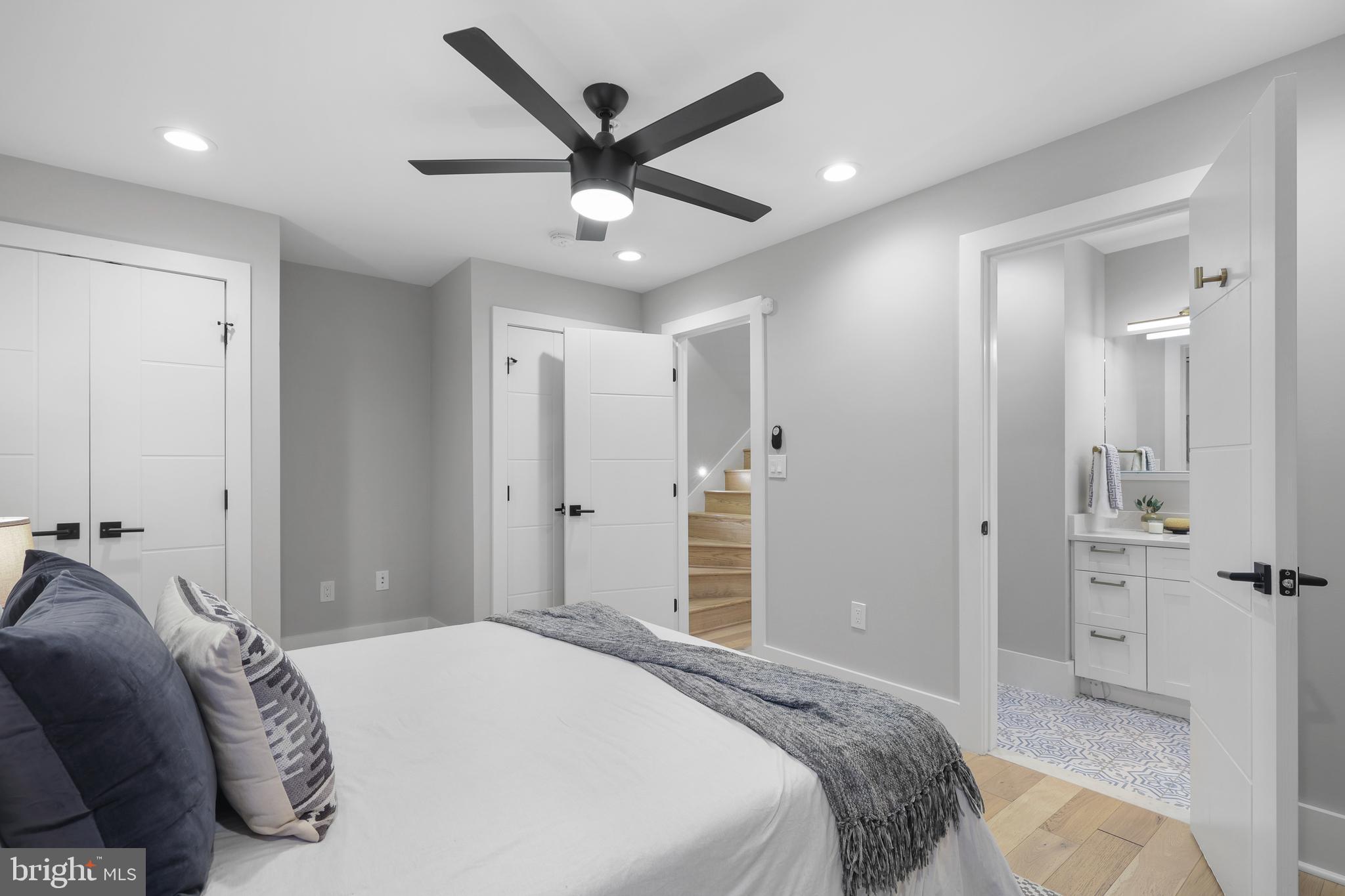 113 U Street Northeast, Unit 1 Washington, DC 20002 - Photo 31 of 63 a bedroom with a large bed and a chandelier