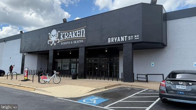 113 U Street Northeast, Unit 1 Washington, DC 20002 - Photo 63 of 63 a view of a building with retail shops and traffic signal