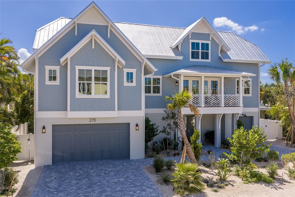 215 Sycamore Avenue Anna Maria, FL 34216 - Photo 1 of 75 a front view of a house with a yard