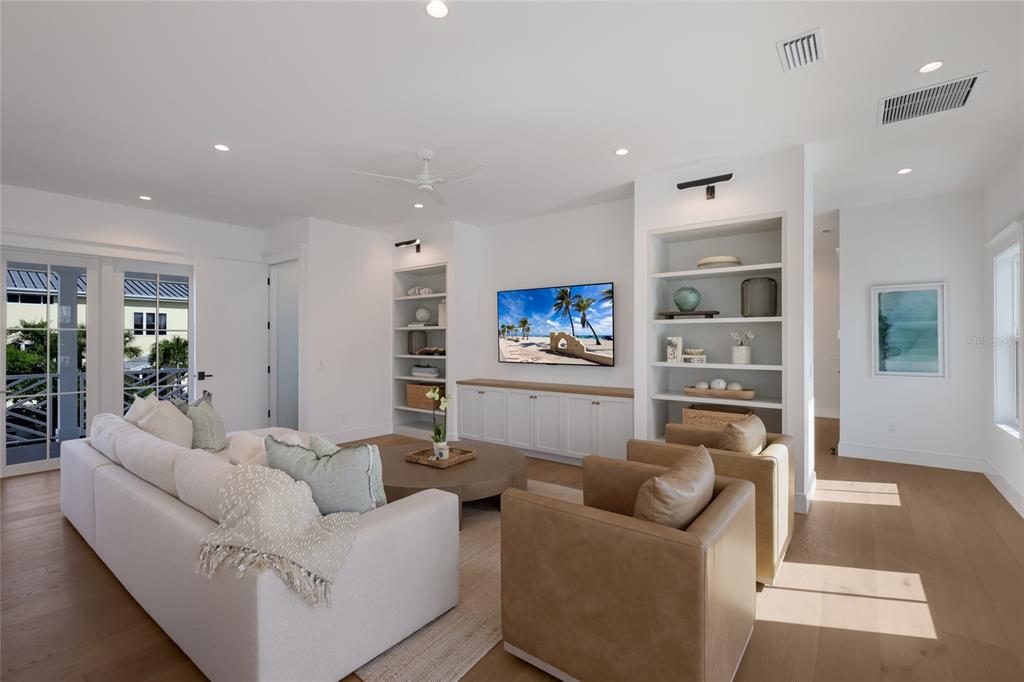 215 Sycamore Avenue Anna Maria, FL 34216 - Photo 13 of 75 a living room with furniture and a flat screen tv