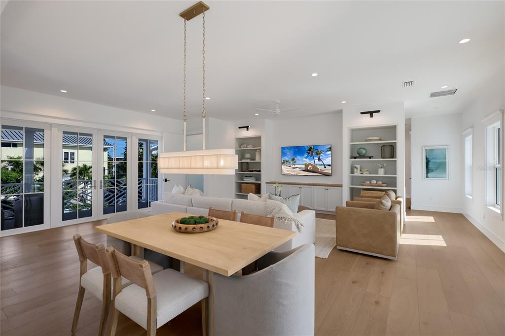 215 Sycamore Avenue Anna Maria, FL 34216 - Photo 16 of 75 a living room with stainless steel appliances furniture a dining table and a floor to ceiling window