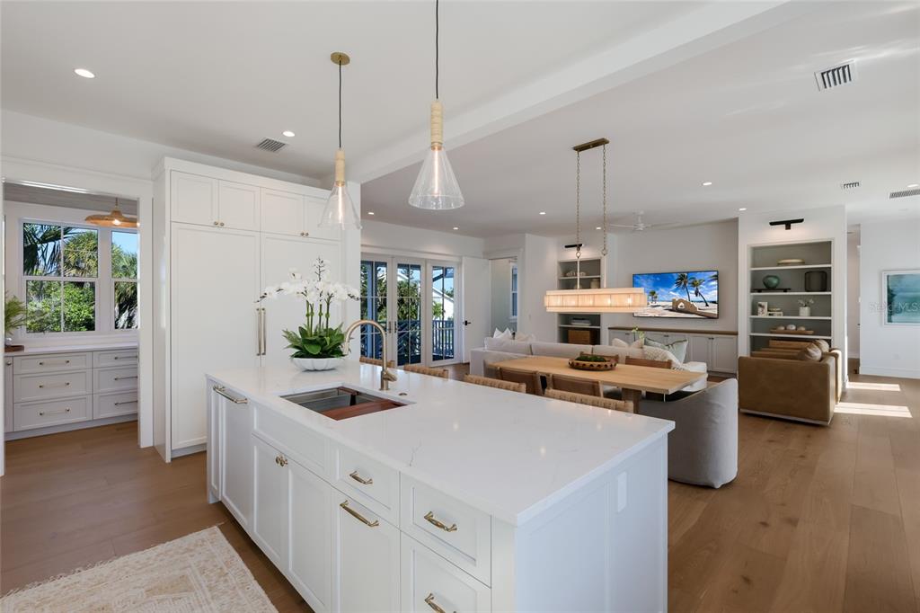 215 Sycamore Avenue Anna Maria, FL 34216 - Photo 20 of 75 a kitchen with stainless steel appliances a stove a sink a oven a dining table and chairs