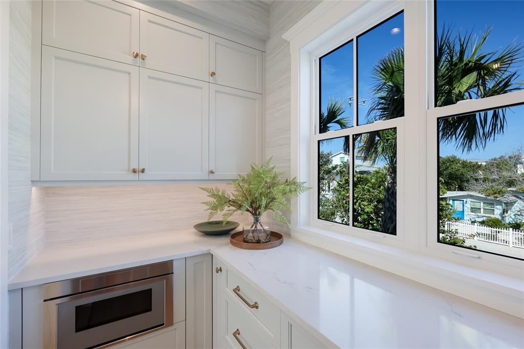 215 Sycamore Avenue Anna Maria, FL 34216 - Photo 25 of 75 a kitchen with stainless steel appliances white cabinets and a potted plant