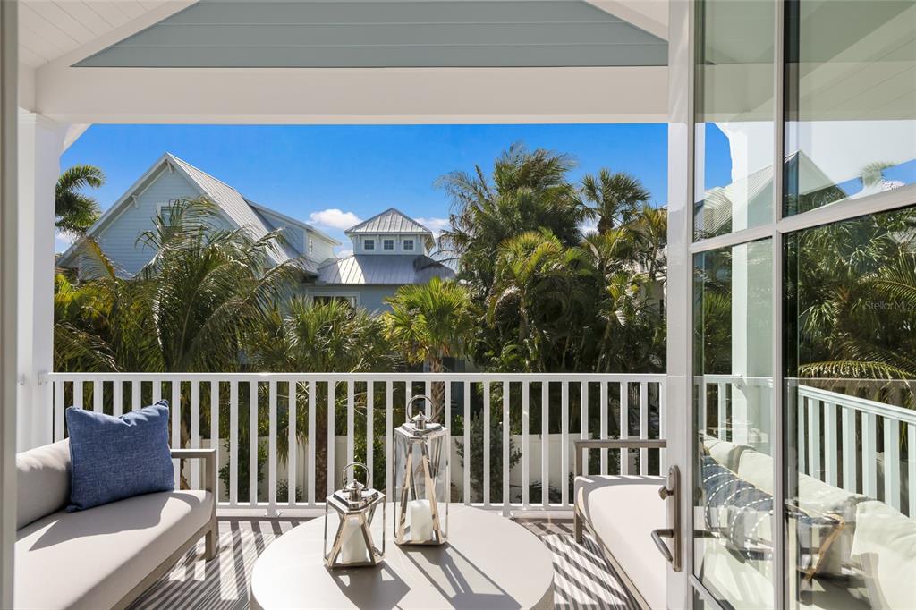 215 Sycamore Avenue Anna Maria, FL 34216 - Photo 27 of 75 a view of a chair and table in the balcony