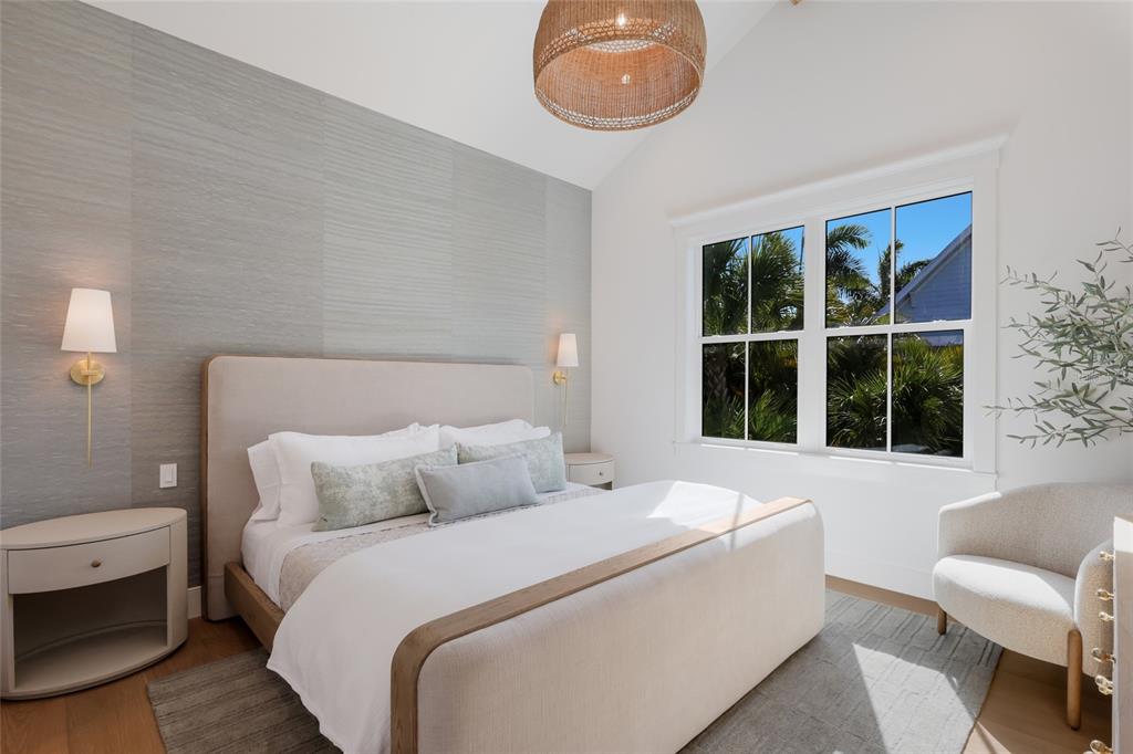 215 Sycamore Avenue Anna Maria, FL 34216 - Photo 29 of 75 a bedroom with a bed and a large window