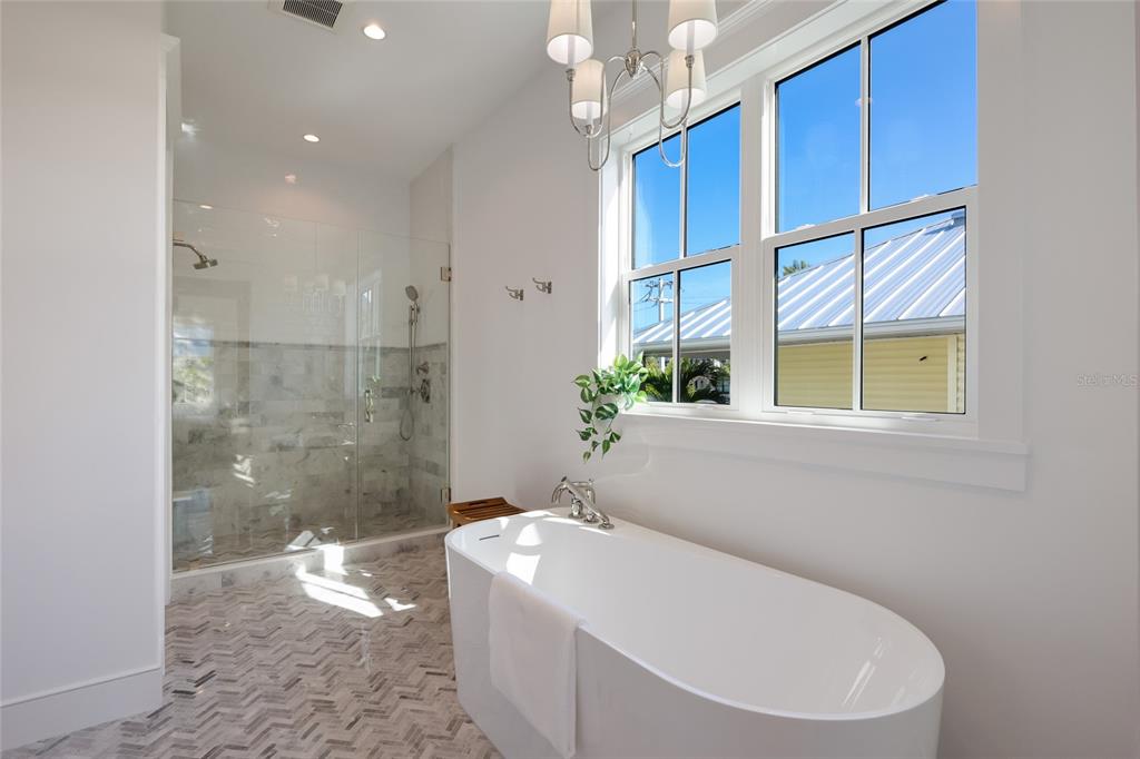 215 Sycamore Avenue Anna Maria, FL 34216 - Photo 33 of 75 a bathroom with a bathtub and shower