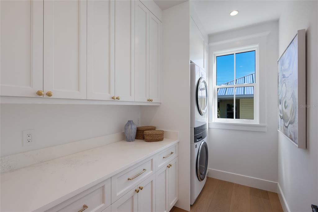 215 Sycamore Avenue Anna Maria, FL 34216 - Photo 34 of 75 a kitchen with a sink and a washer dryer