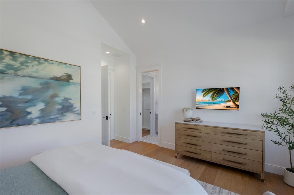 215 Sycamore Avenue Anna Maria, FL 34216 - Photo 36 of 75 a bedroom with a bed and a painting on the wall