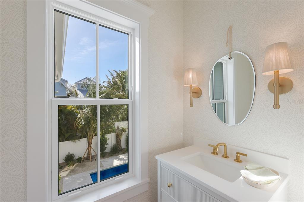 215 Sycamore Avenue Anna Maria, FL 34216 - Photo 39 of 75 a bathroom with a sink and a mirror