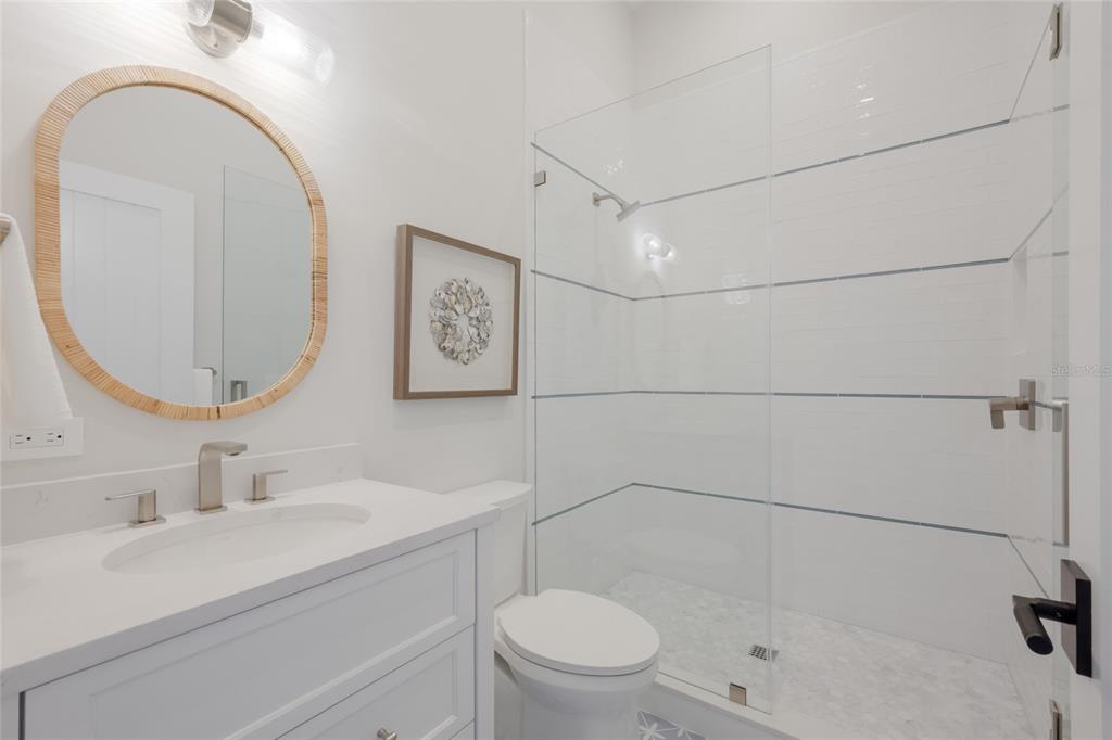 215 Sycamore Avenue Anna Maria, FL 34216 - Photo 44 of 75 a bathroom with a sink a toilet and shower