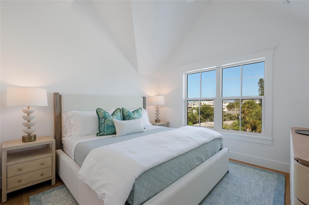 215 Sycamore Avenue Anna Maria, FL 34216 - Photo 45 of 75 a bedroom with a bed and a window