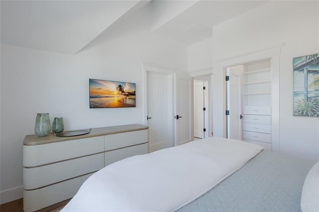 215 Sycamore Avenue Anna Maria, FL 34216 - Photo 46 of 75 a bedroom with a bed and a flat screen tv