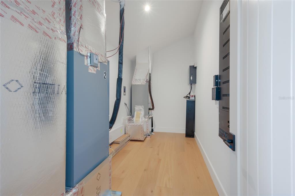 215 Sycamore Avenue Anna Maria, FL 34216 - Photo 47 of 75 a view of a hallway with white walls and door