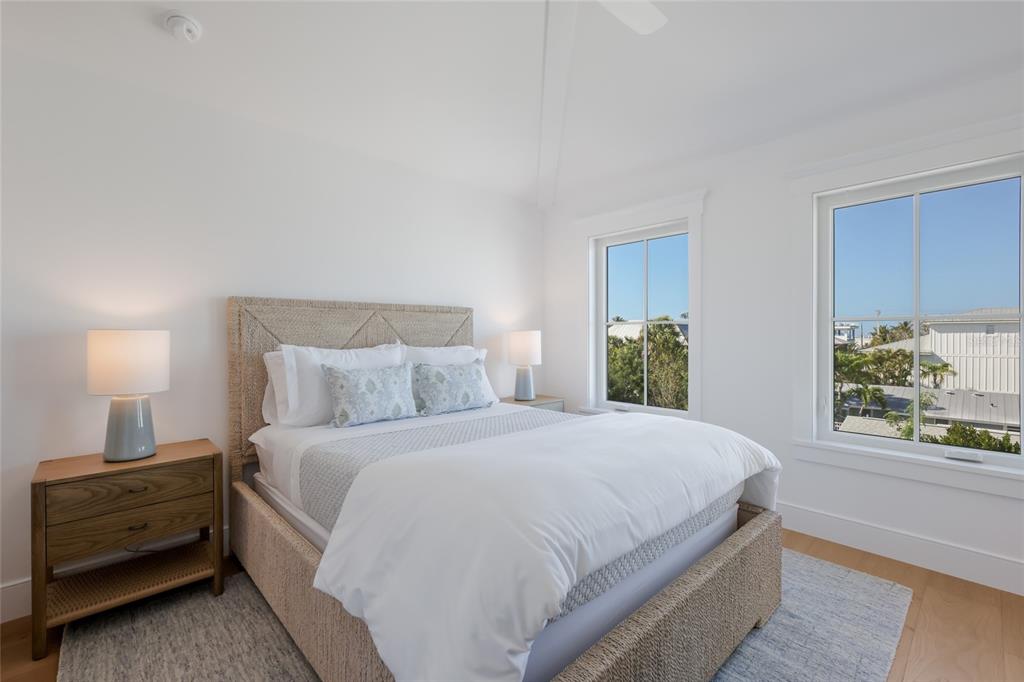 215 Sycamore Avenue Anna Maria, FL 34216 - Photo 48 of 75 a bedroom with a bed and a window