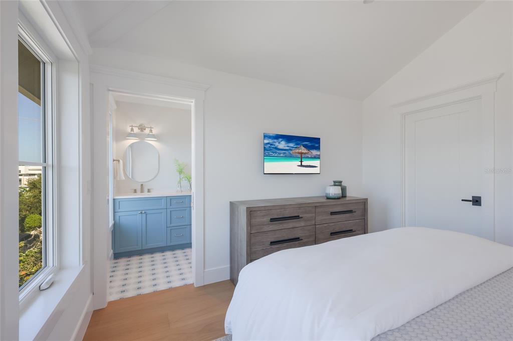 215 Sycamore Avenue Anna Maria, FL 34216 - Photo 49 of 75 a bedroom with a bed and a dresser