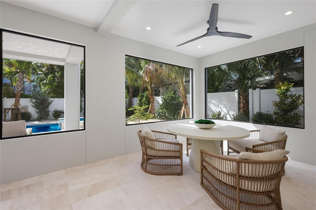 215 Sycamore Avenue Anna Maria, FL 34216 - Photo 54 of 75 a dining room with furniture window and outside view