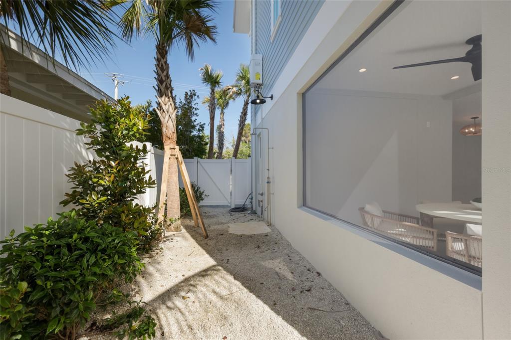 215 Sycamore Avenue Anna Maria, FL 34216 - Photo 68 of 75 a view of a house with a yard and potted plants