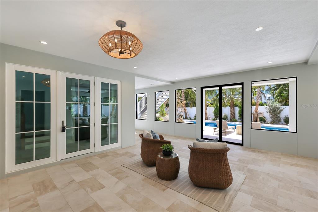 215 Sycamore Avenue Anna Maria, FL 34216 - Photo 7 of 75 a living room with furniture and a large window