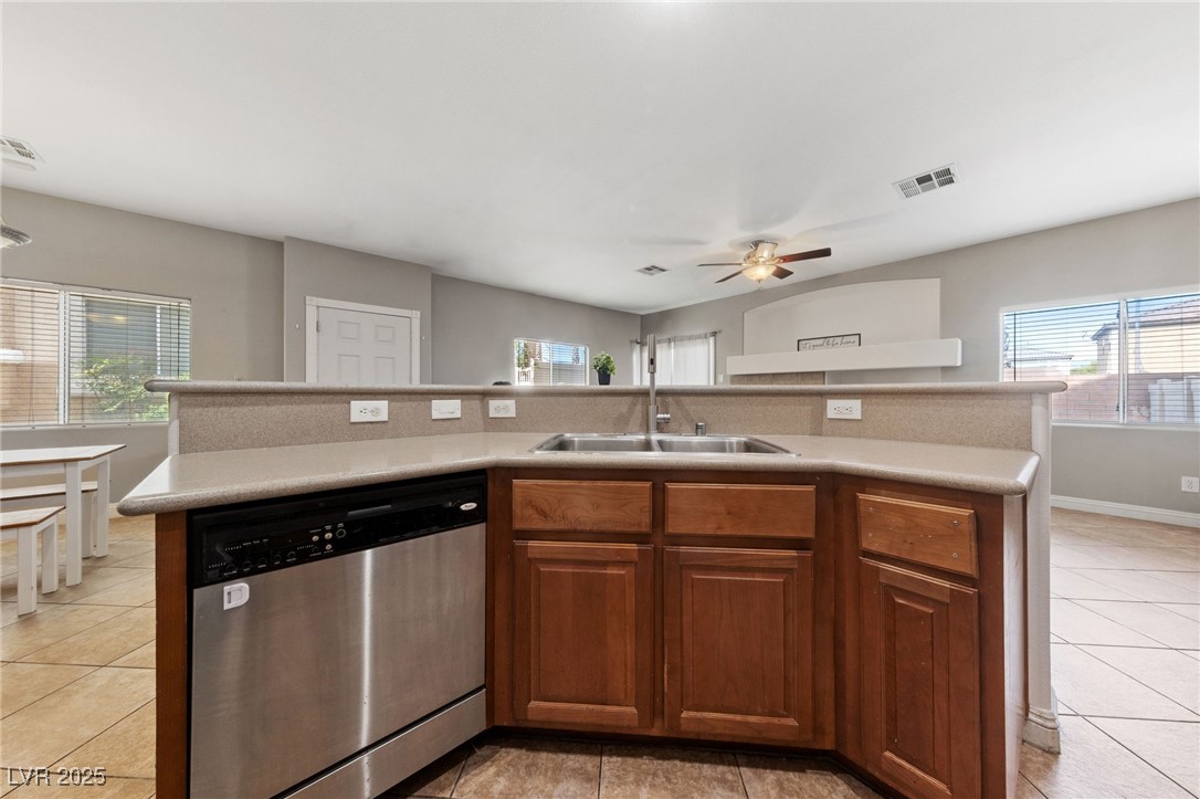 9068 Bushy Tail Avenue, Unit 103 Las Vegas, NV 89149 - Photo 24 of 32 Kitchen featuring a center island with sink and stainless steel dishwasher