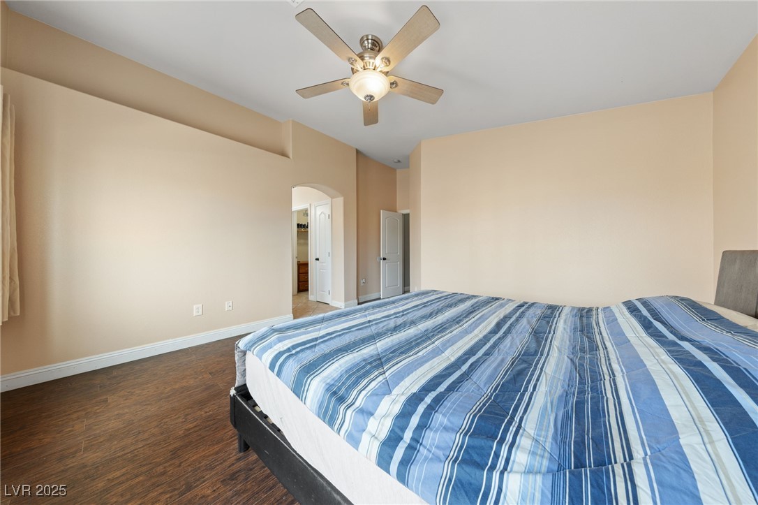 9068 Bushy Tail Avenue, Unit 103 Las Vegas, NV 89149 - Photo 28 of 32 Newly Painted Primary Bedroom with arched walkway to Bathroom