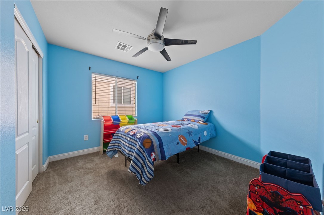 9068 Bushy Tail Avenue, Unit 103 Las Vegas, NV 89149 - Photo 9 of 32 Bedroom 2 with carpet flooring, a closet, and ceiling fan