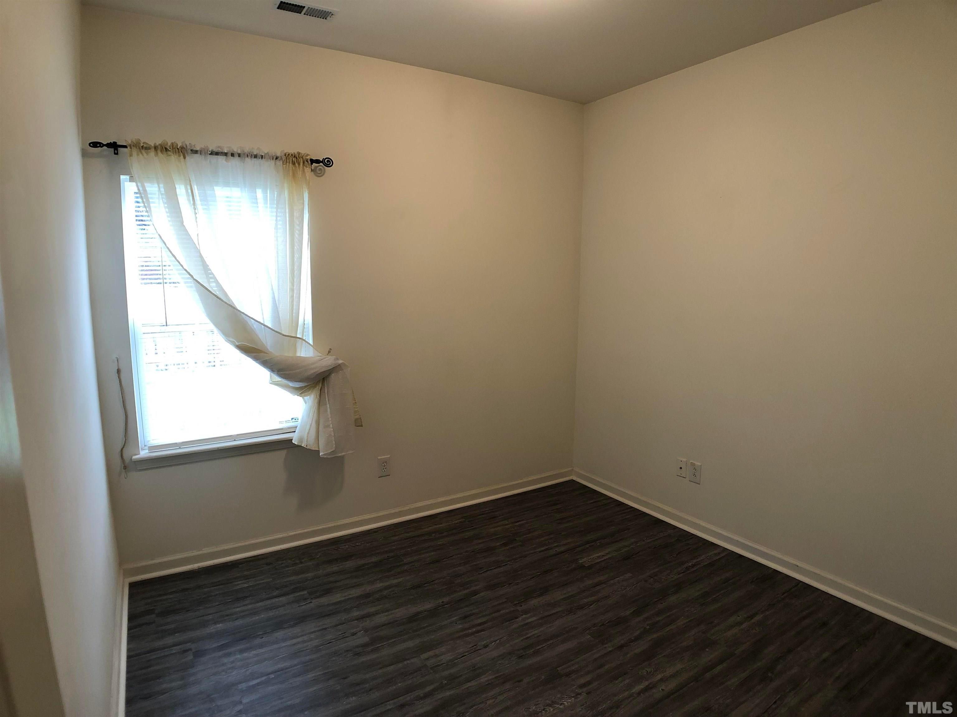 405 Hanson Road Durham, NC 27713 - Photo 13 of 27 an empty room with wooden floor and windows