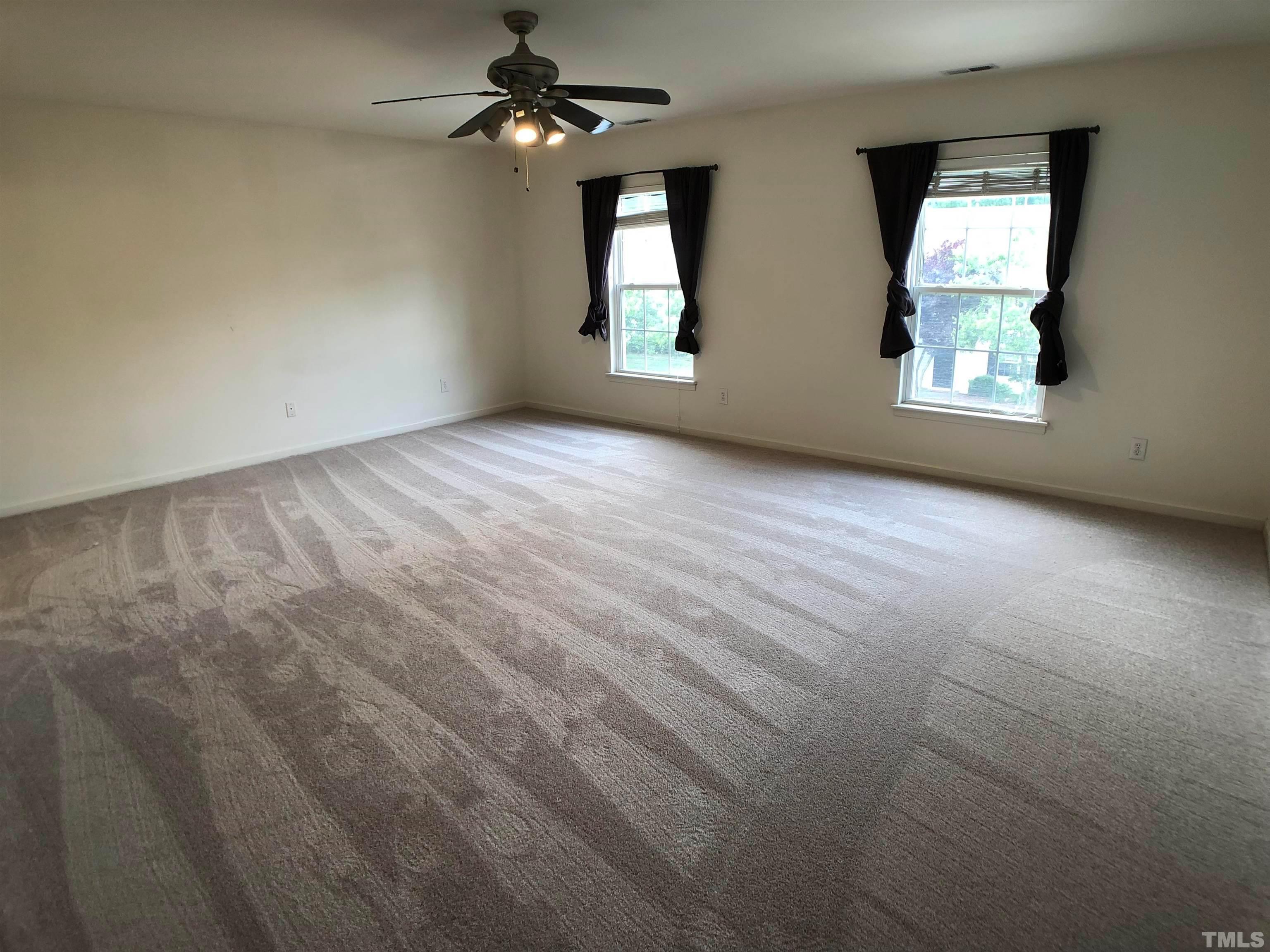 405 Hanson Road Durham, NC 27713 - Photo 15 of 27 an empty room with windows and ceiling fan